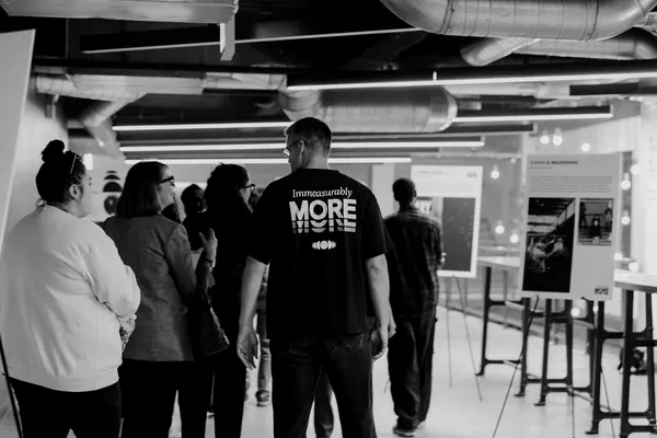 People looking at the Immeasurably More renderings