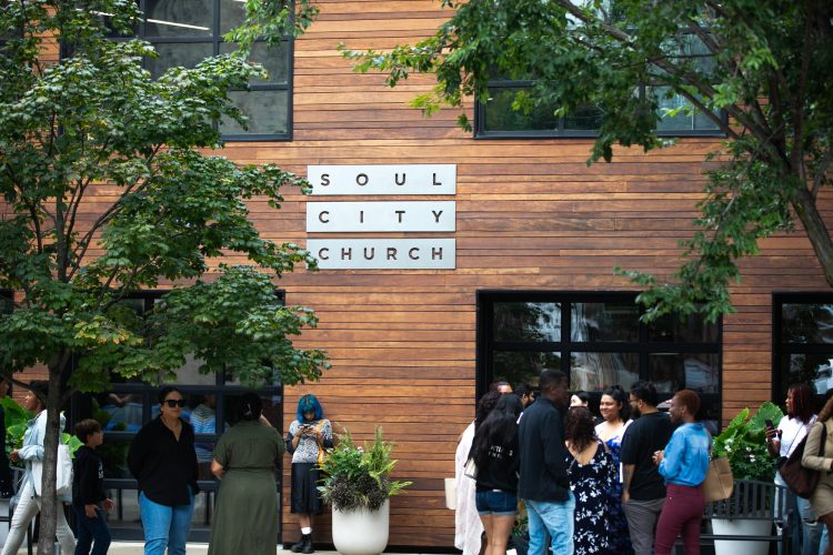 People gathered outside the Soul City Church entrance on West Adams Street
