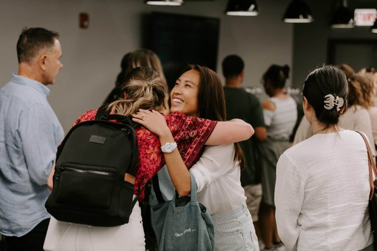 Two people hugging in the lobby after a Sunday gathering